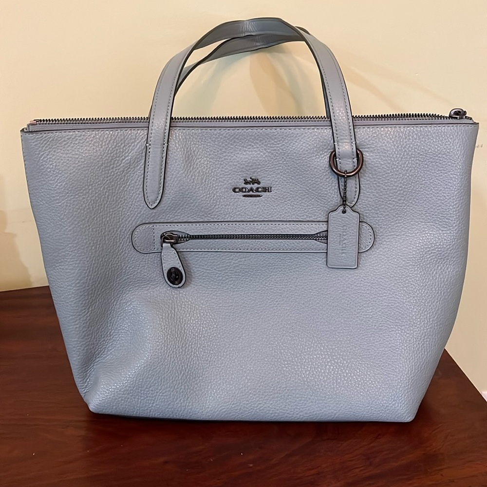 Coach bag. Never used. Still has tags. Coach storage bag included. 15” x 11”